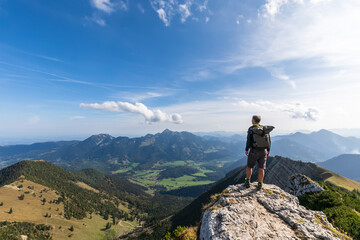 Male hiker admiring view from summit of Aiplspitz mountain