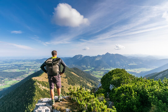 Male hiker admiring view from summit of Aiplspitz mountain