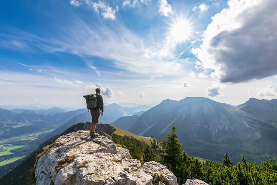 Male hiker admiring view from summit of Aiplspitz mountain