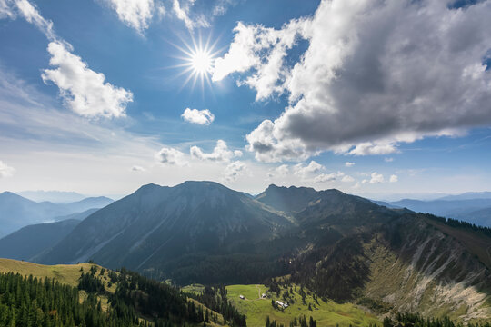 Summer sun shining over valley in Alps