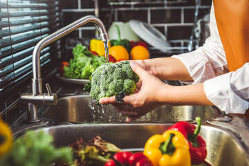 Hand of maid washing tomato fresh vegetables preparation healthy food in kitchen © joyfotoliakid
