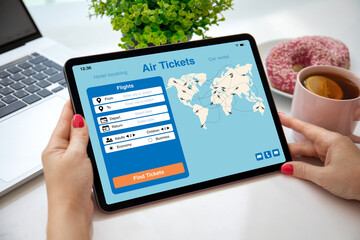female hands holding computer tablet with application searching air tickets © DenPhoto
