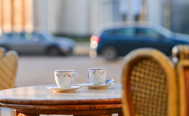 Two cups of espresso coffee on a coffee shop terrace from Paris, France.