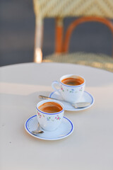 Two cups of espresso coffee on a coffee shop terrace from Paris, France.