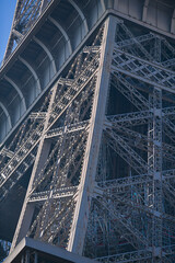 Details of the structure of Eiffel Tower landmark building from Paris, France, in a sunny day