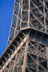 Details of the structure of Eiffel Tower landmark building from Paris, France, in a sunny day