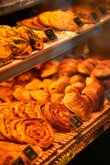 Tasty French pastry in a patisserie sweets shop from Paris. Quiches, croissants and other specific breakfast foods of France.