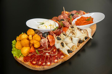 Antipasti served on a wooden board