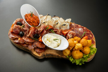 Antipasti served on a wooden board