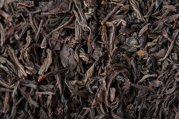 Close-up view of dried leaves of black tea. Black tea background
