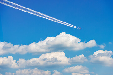Beautiful storm clouds, cumulus clouds or cumulonimbus against a clear blue sky with an airliner...