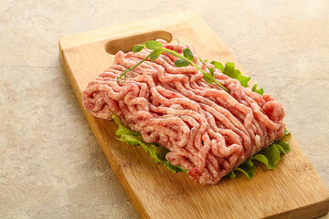 Raw minced pork meat over board