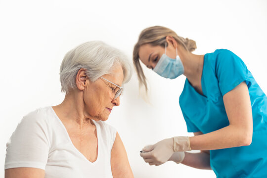 Vaccine shot as a prevention of viruses. Caucasian elderly patient gets her vaccine dose to be safe. High quality photo