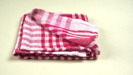 Folded kitchen textile towels of different colors, Household cleaning cloth. Closeup of cleaning rag isolated on a white background.
