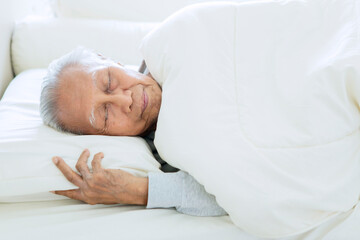 Obraz na płótnie Canvas Elderly man sleeping well on the comfortable bed