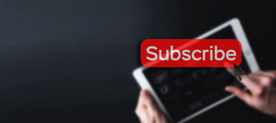 Subscribe button. Online video subscription red button. Internet service on laptop digital tablet blured banner background. Visual contents concept. Social networking service.