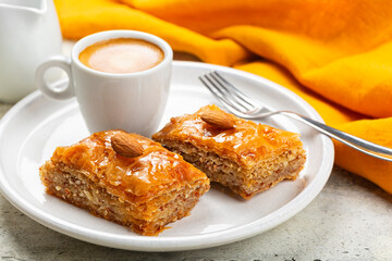 Middle Eastern and Mediterranean Baklava and espresso coffee. Layered pastry dessert made of filo pastry, filled with chopped almond nuts, and sweetened with syrup or honey.  Homemade.