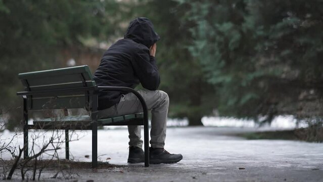 Man sitting on a bench and feeling lonely and depressed