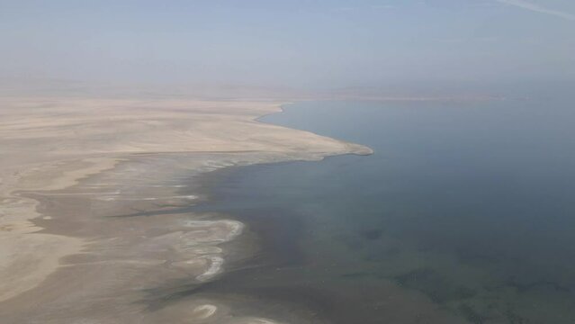 Flat featureless chala desert in Peru extends to Pacific coast, aerial