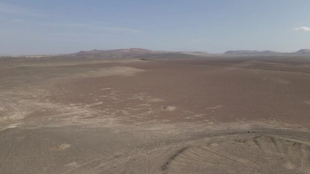 Expansive desert sand dunes aerial near Peruvian coast at Paracas
