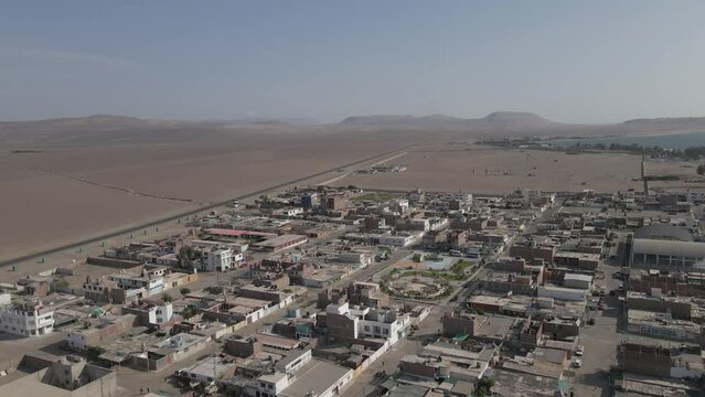 Aerial flyover of small desert port town of Paracas on mid-coast Peru