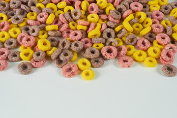 Rainbow rings close-up on a white background. Ready-made breakfasts, cornflakes.