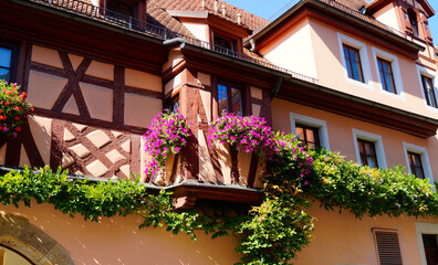 Fototapeta na wymiar a beautiful old house with flowers on the windowsill on island of Lindau in Germany