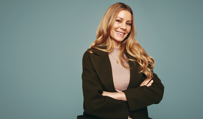 Cheerful woman smiling at the camera in a studio