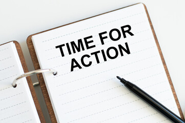 TIME FOR ACTION text on notepad on table