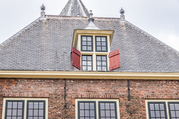 Obraz premium Architectural fragments of XV century De Waag building (Weigh House) at Nieuwmarkt square in Amsterdam. De Waag was one of the gates in the old Amsterdam city wall. Amsterdam, Netherlands.