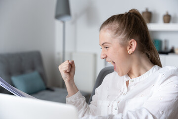 Young freelancer woman celebrating good results.