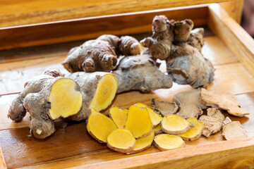 Cassumunar ginger (Zingiber montanum (Koenig) Link ex Dietr.), Phlai sliced on wooden table...