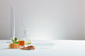 Honey and turmeric decorated with transparent podium and beaker test tube with blank space in white laboratory background for experiment advertising , top view 