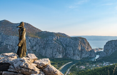 Amazing view of Cetina river canyon and statue of Croatian heroine near the town of Omis, Dalmatia region of Croatia.