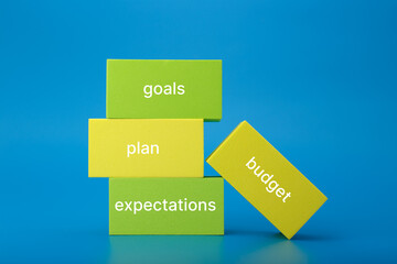 Business plan concept. Text budget, plan, goals, expectations written on colored rectangles against...