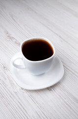 Coffee. White cup of coffee, side view