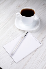 Office supplies and a white cup of coffee on the table. Office work or work at home