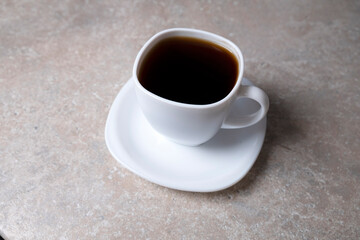 A cup of coffee on a stone table. Drink for the morning
