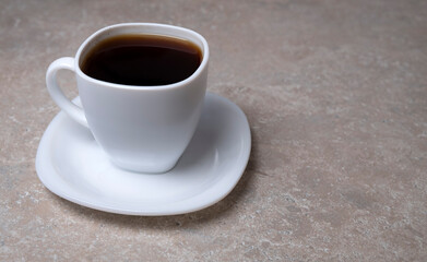 A cup of coffee on a stone table, top view. Drink for the morning. Drink when you want to sleep