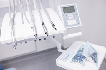 Cute woman sits in dentist chair while dentist examine her teeths. Selective focus