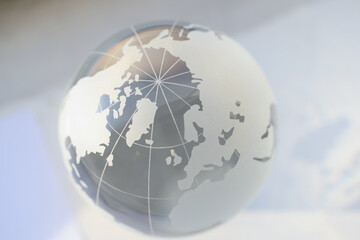 Grey glass world globe, round shaped earth miniature with continents