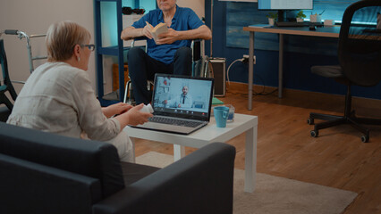 Patient talking to doctor on video call consultation, meeting with specialist on online conference. Old woman using laptop to talk to medic on remote teleconference for telecommunication.
