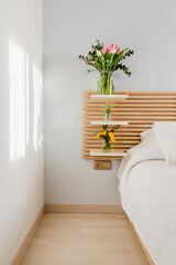 Bouquets of colorful flowers in vases on a headboard at sunset