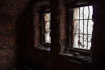 Fototapeta na wymiar Abandoned brick building barred windows