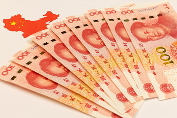 Renminbi, or RMB, CNY, currency of China. Set of one hundred yuan close up. Chinese money. Business concept. China map and national flag in white background