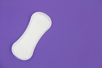 women's white hygienic daily pads on a purple background very peri