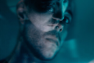 A man's face in a blur without computer effects, a photo in a room with light