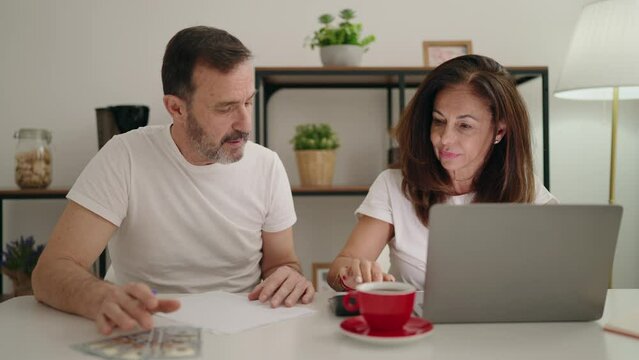 Man and woman couple controlling economy at home