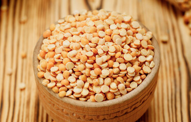 Pea groats in bowls and bags on a wooden background. High quality photo