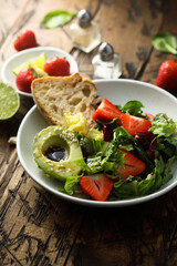 Healthy leaf salad with strawberry and avocado